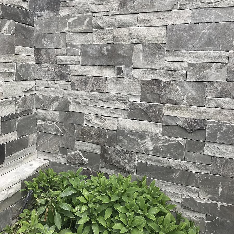 Our natural stone thin veneer in Black Horse is a beautiful smokey black sedimentary stone with crystallized veining perfect for an elegant retaining wall.