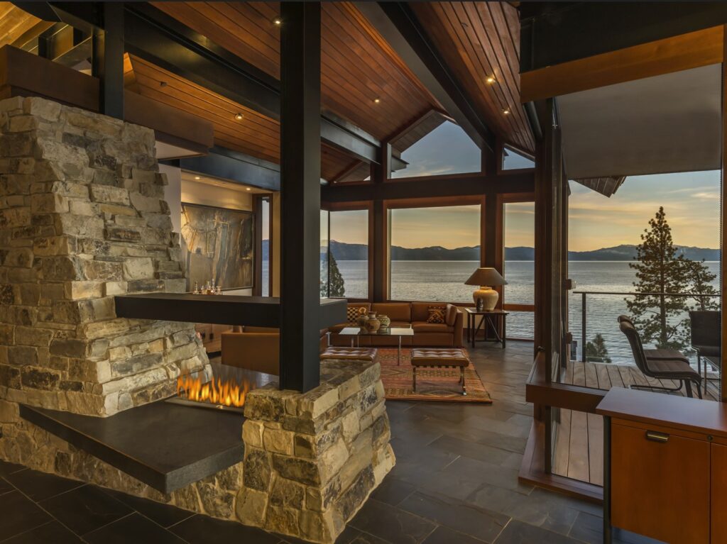 A natural stone fireplace with a mantel made from travertine, featuring unique clefting and topography that add character and depth to the room.