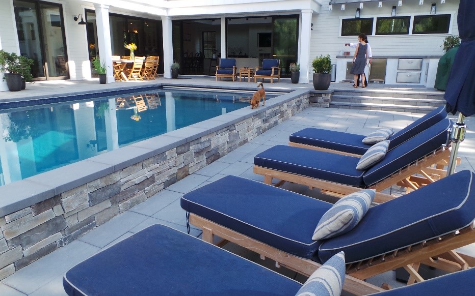 Natural stone pool decks with travertine and bluestone