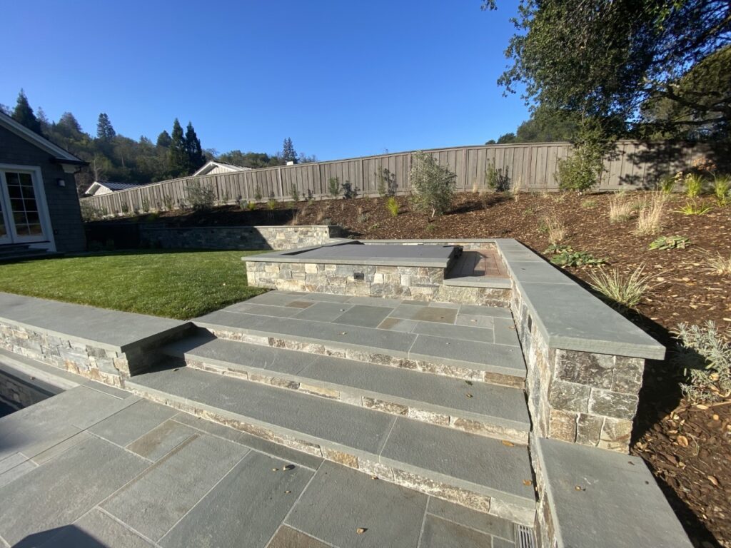 finished retaining wall project with natural stone