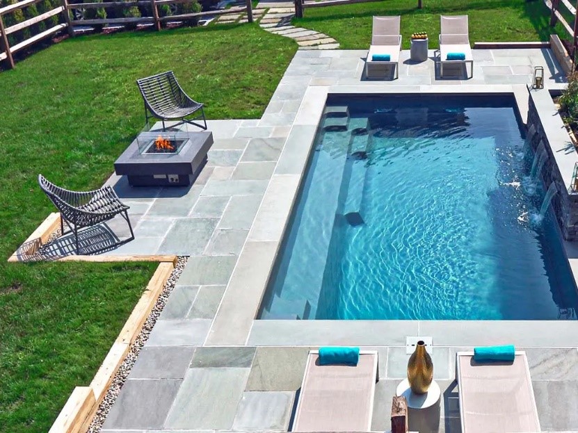 Luxurious pool featuring limestone eased edge coping, enhancing safety with a sleek, slip-resistant finish perfect for upscale pool designs