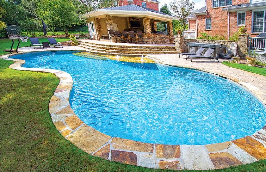 ustic flagstone mosaic coping running along the pool edge, creating a unique, organic look with a textured, slip-resistant surface for enhanced safety.