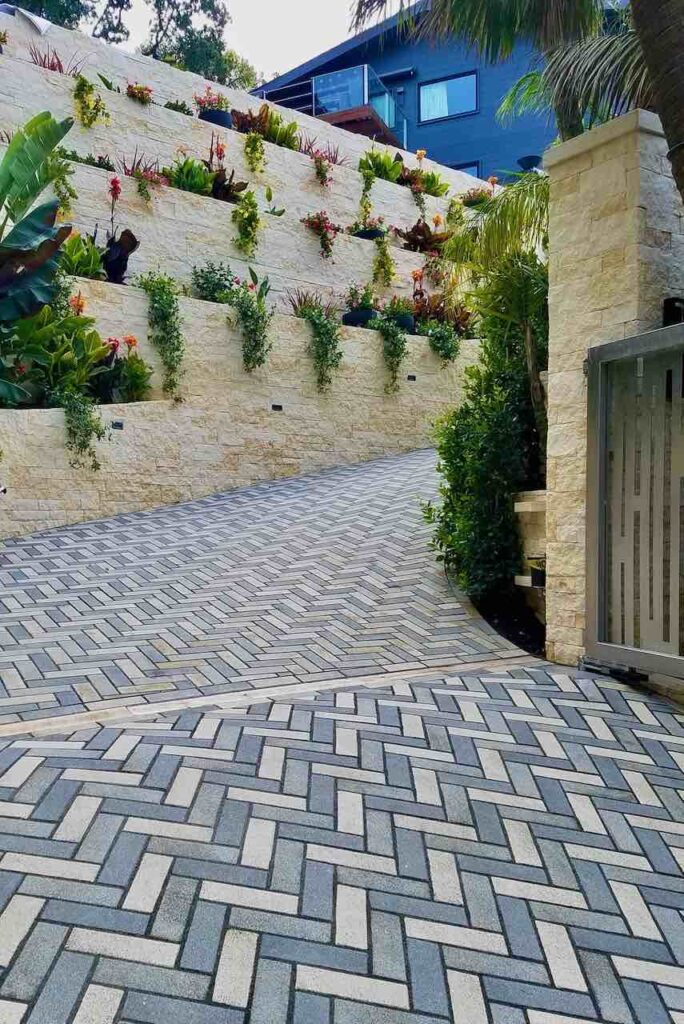 Solped driveway through entry gate using Akerstone Pavers in Aqualine colors.