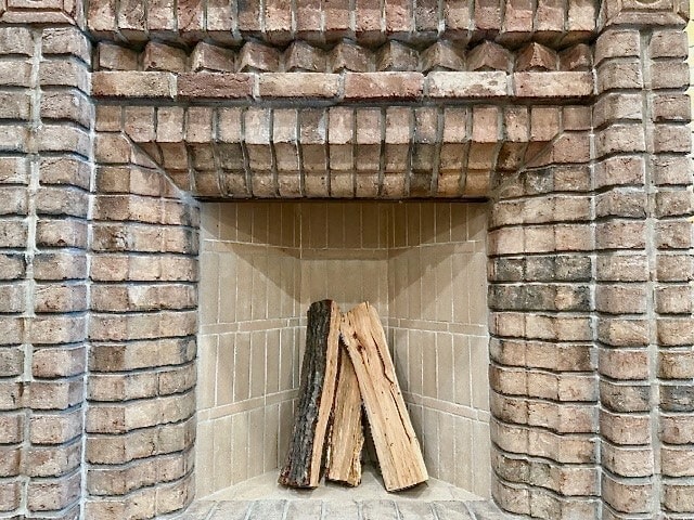 A beautifully crafted brick fireplace with intricate brickwork details, creating a warm and inviting focal point for indoor or outdoor spaces.