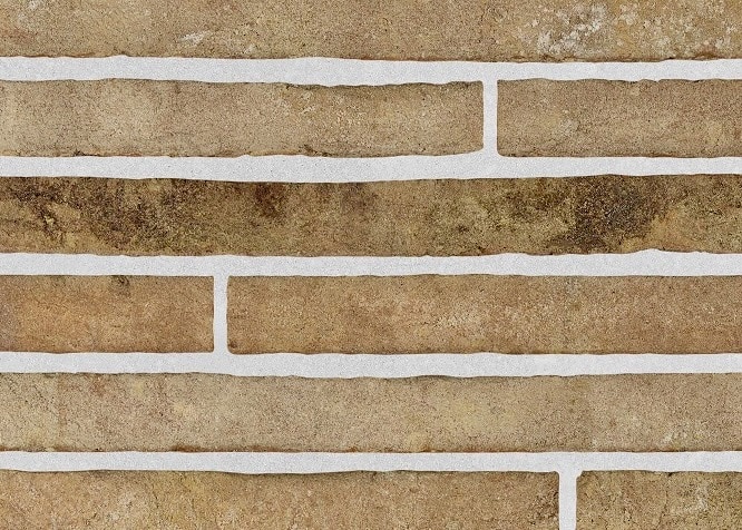 A close-up of Arno textured full bricks in earthy tones with white mortar, showcasing a rustic and natural aesthetic for architectural and landscape designs.