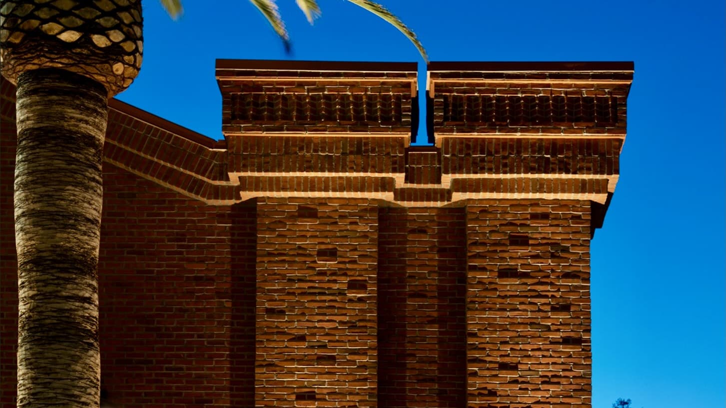 A beautifully illuminated red brick building showcasing intricate masonry details, enhancing its historic and architectural appeal.