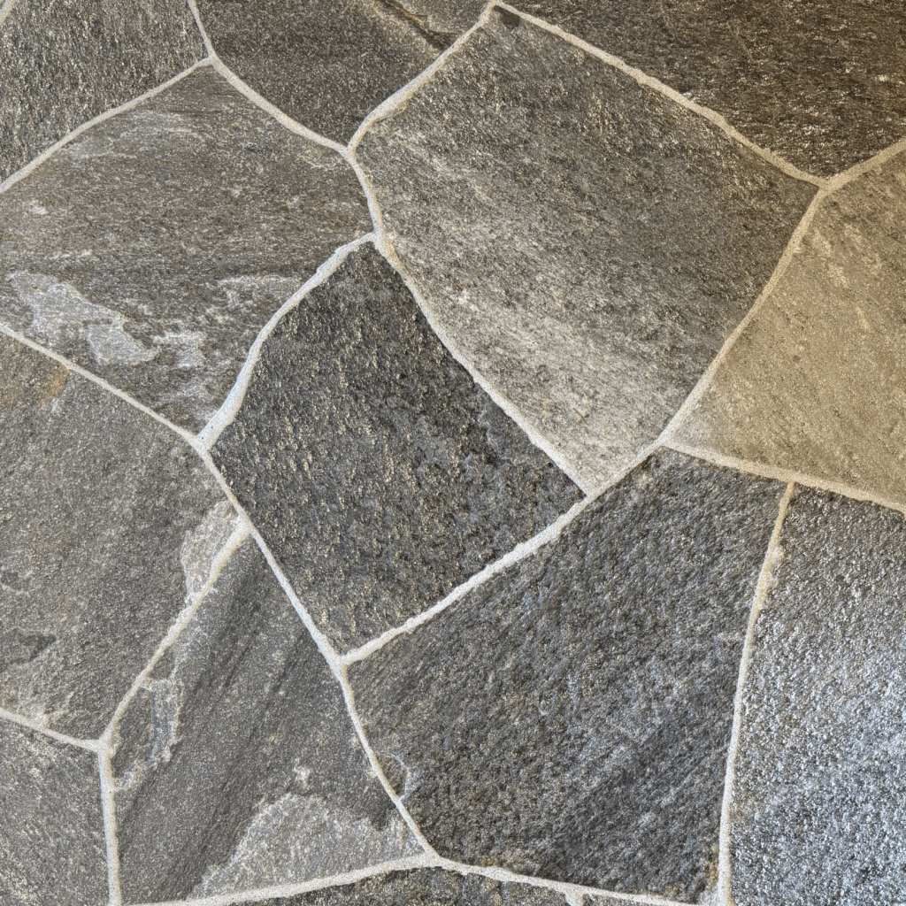 Close-up of Idaho Charcoal Quartzite Flagstone showing deep gray hues and natural metallic veining