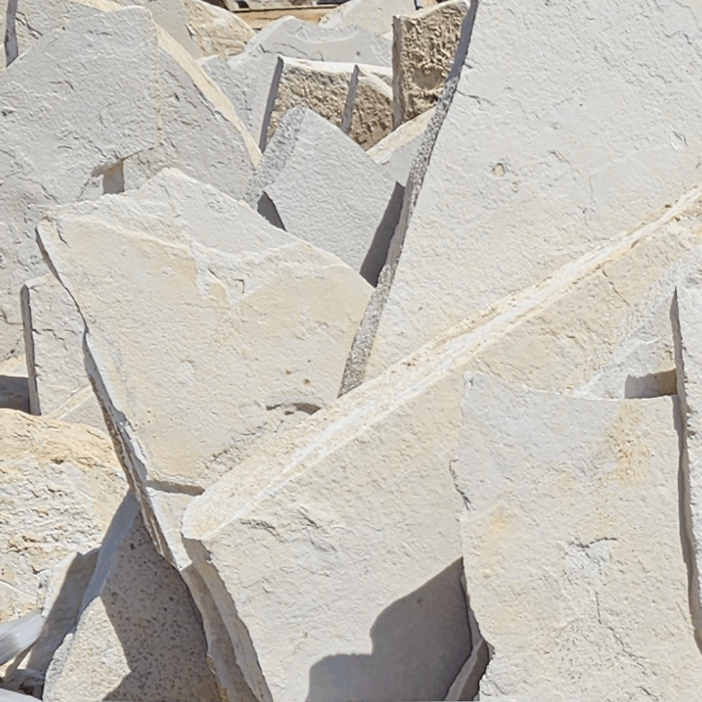 Tuscan Cream Limestone Flagstone with light ivory tones, minimal veining, and rough natural surface texture in irregular shapes
