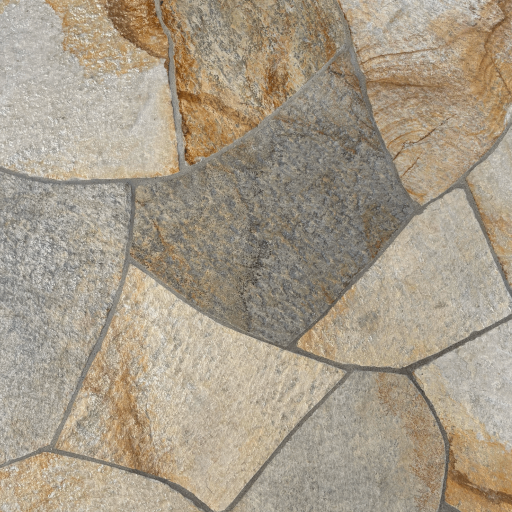 Irregular pattern of Idaho Gold Quartzite Flagstone with beige-gray base, rust-orange veining, and metallic flecks