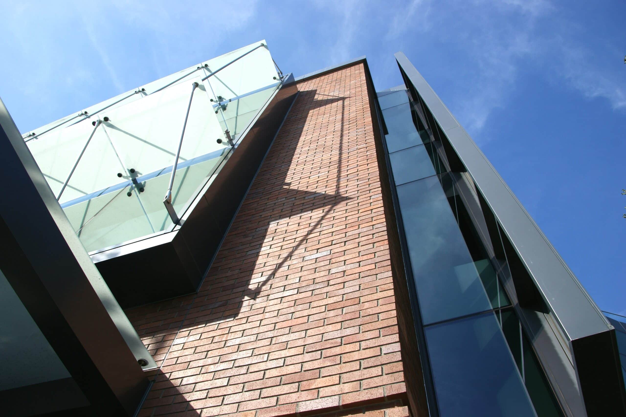 A beautifully illuminated red brick building showcasing intricate masonry details, enhancing its historic and architectural appeal.