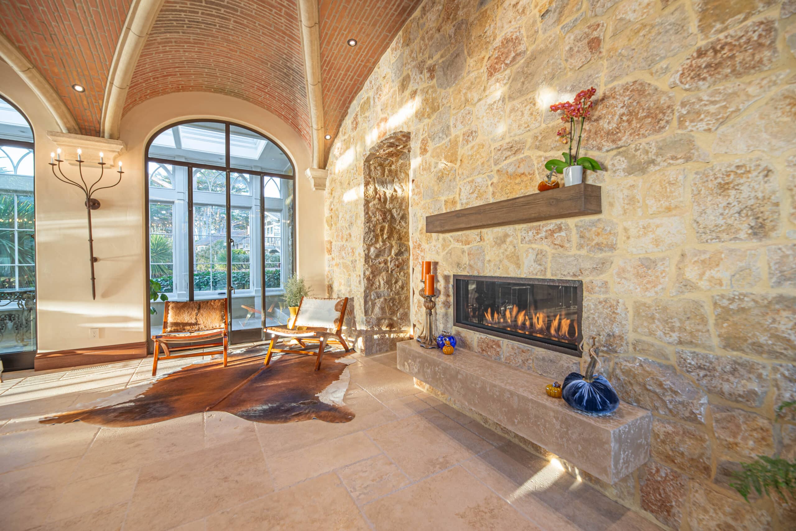 A charming stone-clad home with a rustic flagstone walkway, blending natural beauty with timeless architectural elegance.