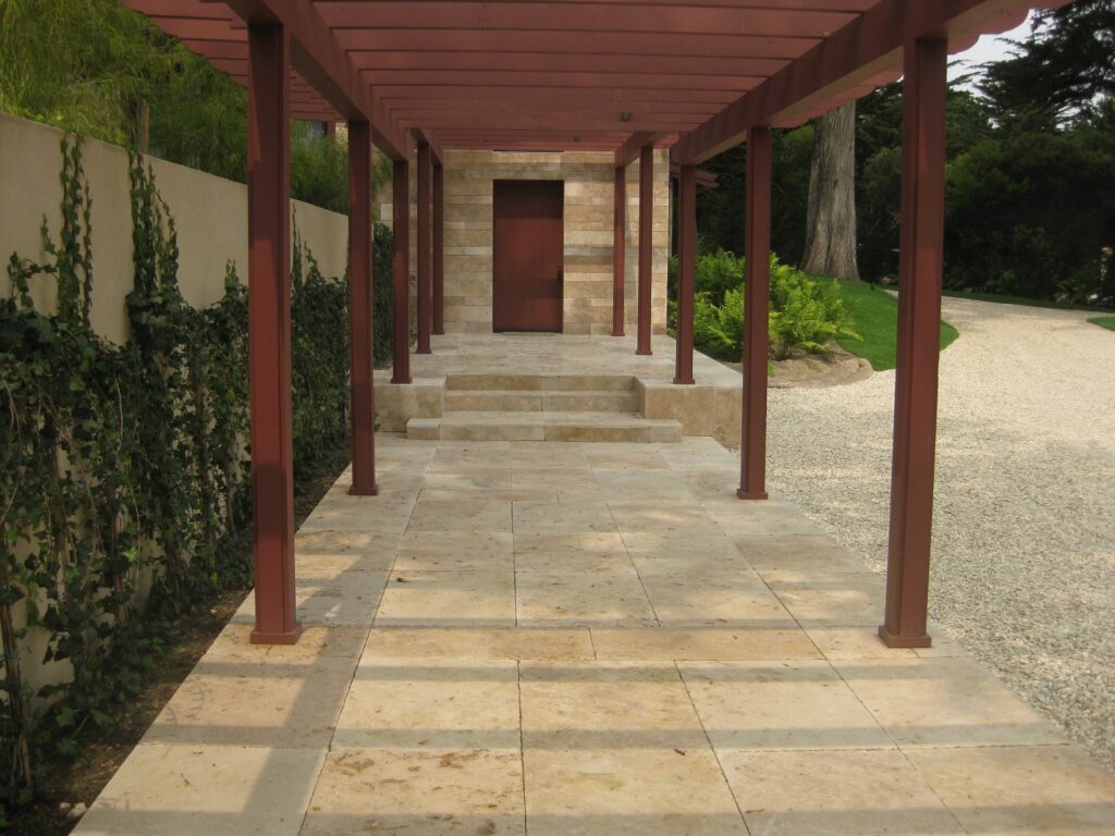 Cremino travertine paver walkway under a pergola with steps to a modern entry.