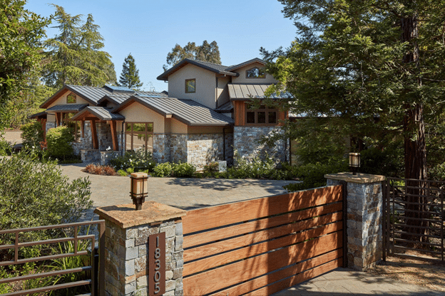 Traditional home exterior accented with natural stone veneer and flagstone walkway at entry.