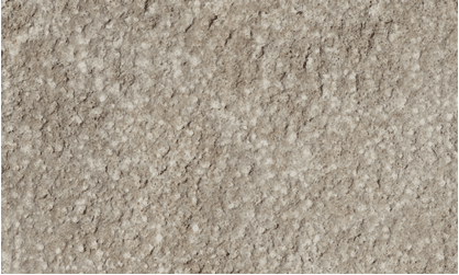 Close-up of light beige bush-hammered stone surface with a dense field of small dimples and a rugged texture.