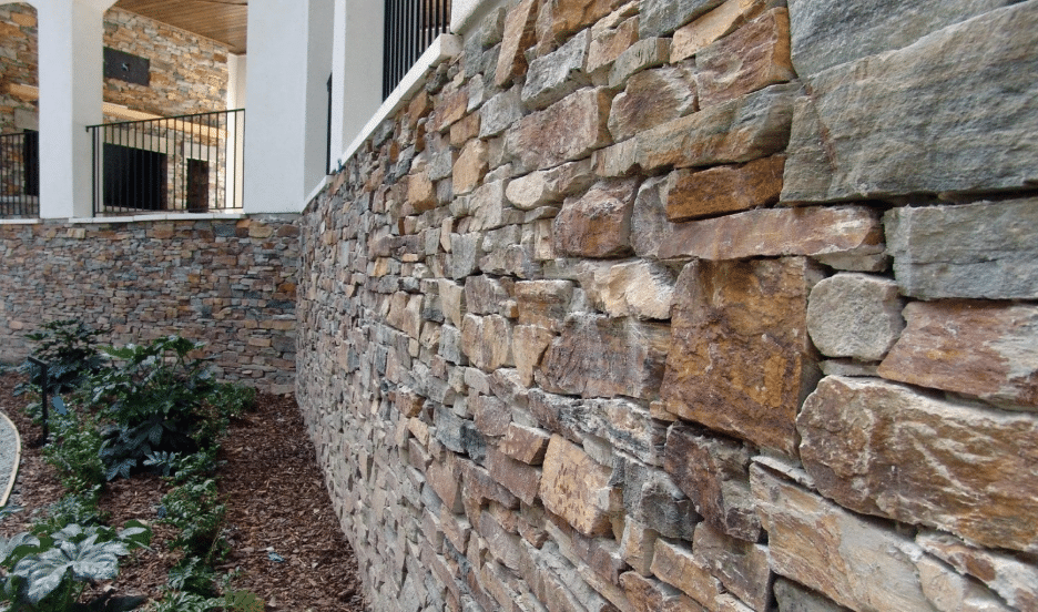 Natural stone veneer installed in the tight-fit, dry-stacked style with staggered joints and minimal grout lines