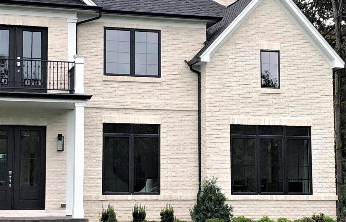 Chalkdust TundraBrick - Modern Collection exterior of the front of the home. Brick is cream to off white color.